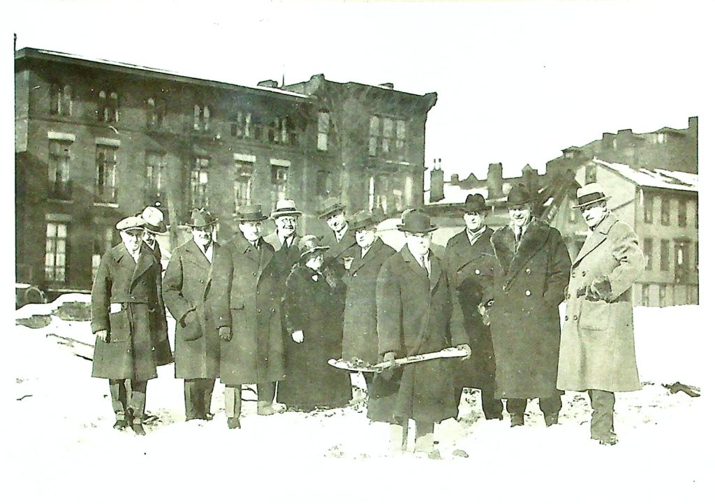 Michael Shea leads the groundbreaking ceremony on January 15, 1925, shovel in hand, as local business owners gather on Main Street to support this monumental project. The event marked the beginning of what would become a Buffalo landmark, symbolizing the community's excitement for the future Shea's Buffalo Theatre.